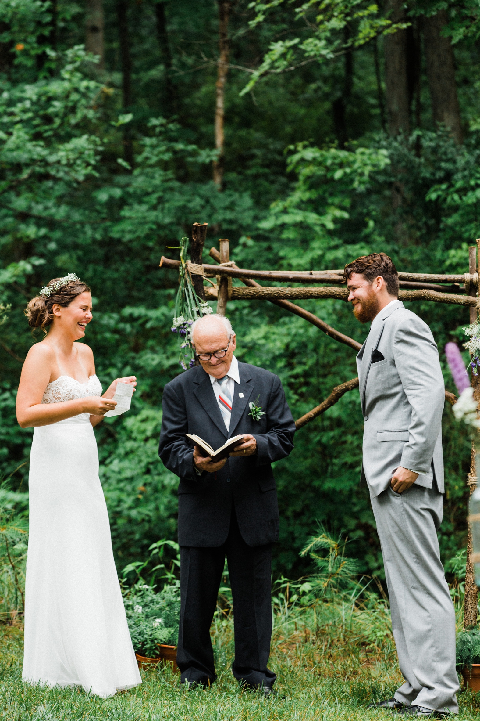 Bride and groom reading vows in outdoor wedding ceremony at Little Piney Lodge in Hermann Missouri (MO)