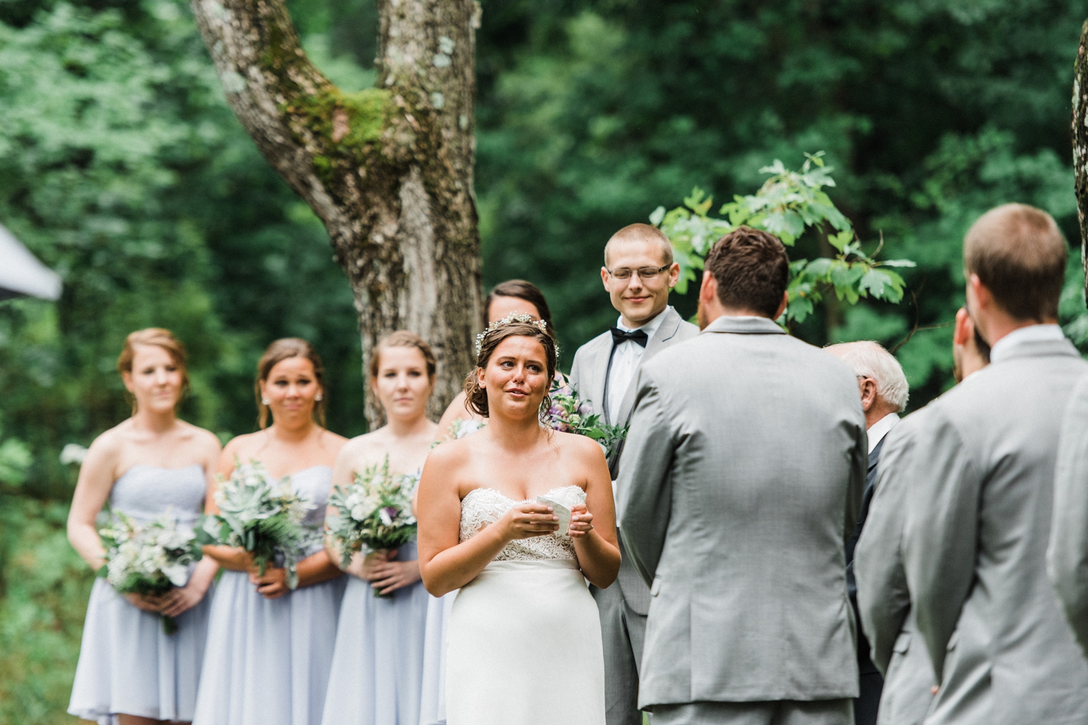 Outdoor wedding ceremony at Little Piney Lodge in Hermann MO, bride and groom reading vows