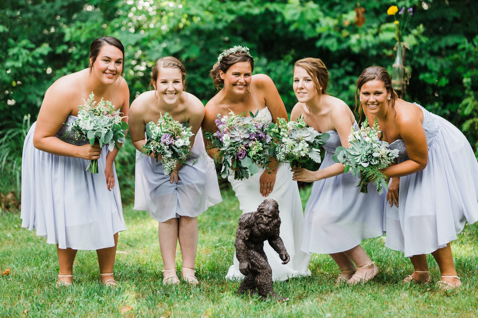 Bride and bridesmaids smiling with bouquets; purple bouquets with succulents and eucalyptus