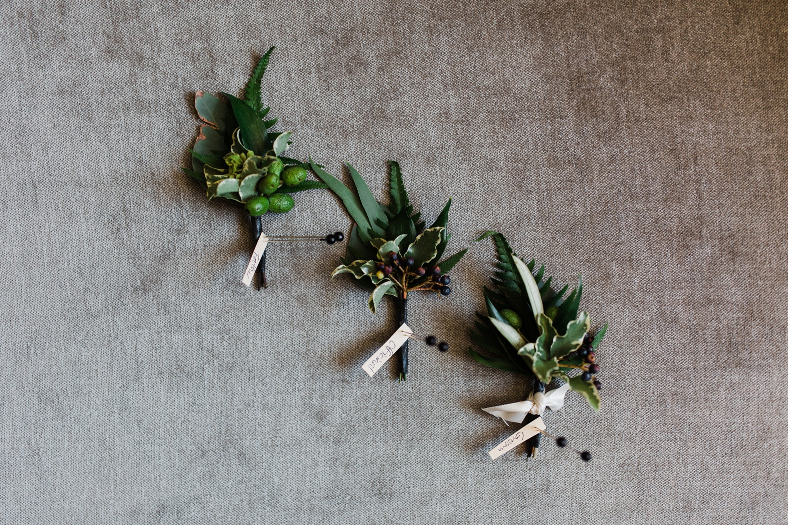 Greenery boutonnieres for groom and groomsmen.