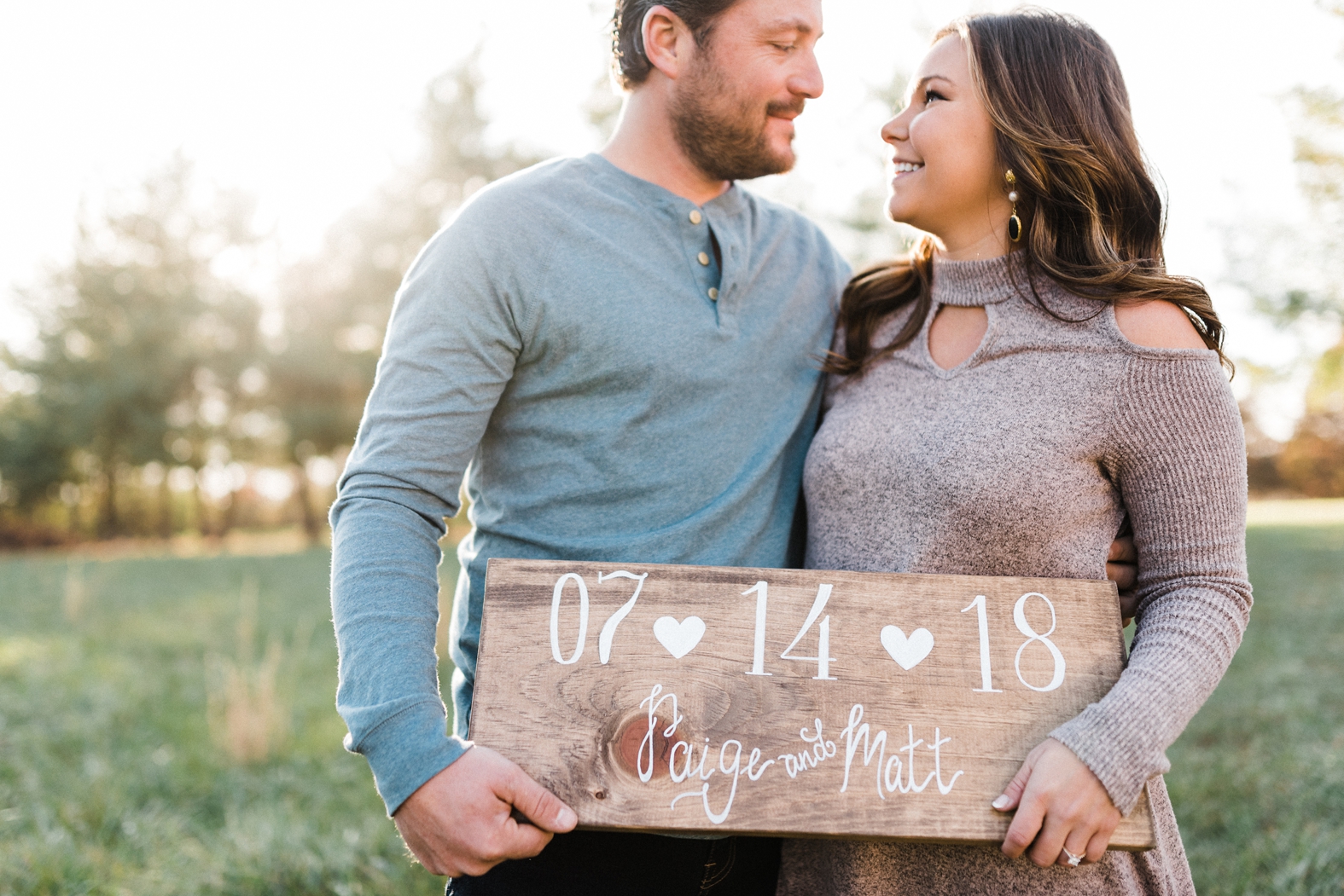 St Louis Engagement Photographer, St Louis Louis Wedding Photographer, couple holding sign with wedding for engagement pic